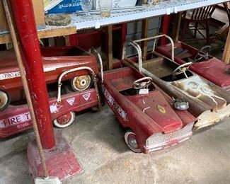 dozens of vintage pedal cars