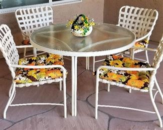Outdoor patio table and chairs. Prettiest cushions you ever saw!