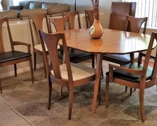 Mid-century modern kitchen/dining table with leaves and eight chairs. Rug also available.