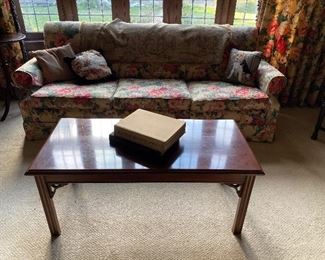 Floral sofa, coffee table, books