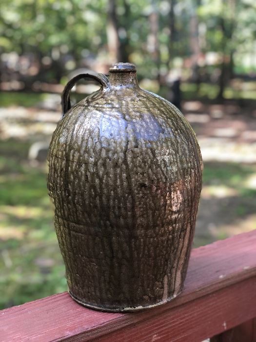 Lot 1: Edgefield Ovoid Jug, 3 Gall, some chipping on rim and a raw-exposed pottery indentation on side from either damage or a lean-to mark during making (see photos), No cracks; Markings: Two straight hash marks at bottom/body of the jar; Measuring 13" tall, 10" widest point. Purchase Price: $1,250.