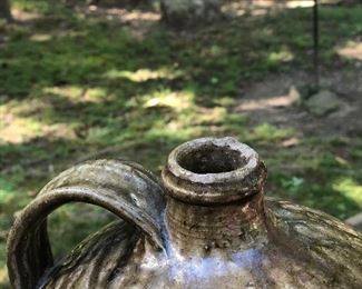 Lot 1: Edgefield Ovoid Jug, 3 Gall, some chipping on rim and a raw-exposed pottery indentation on side from either damage or a lean-to mark during making (see photos), No cracks; Markings: Two straight hash marks at bottom/body of the jar; Measuring 13" tall, 10" widest point. Purchase Price: $1,250.