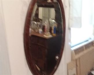 1 of two oval beveled glass oak framed mirrors