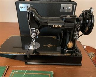 #64 Singer Featherweight Sewing machine serial #AK579219 it is clean, wheel turns smoothly, it has metal bobbin housing, attachments, foot pedal, booklet, and case, it is in beautiful condition!	 $375.00 		
	