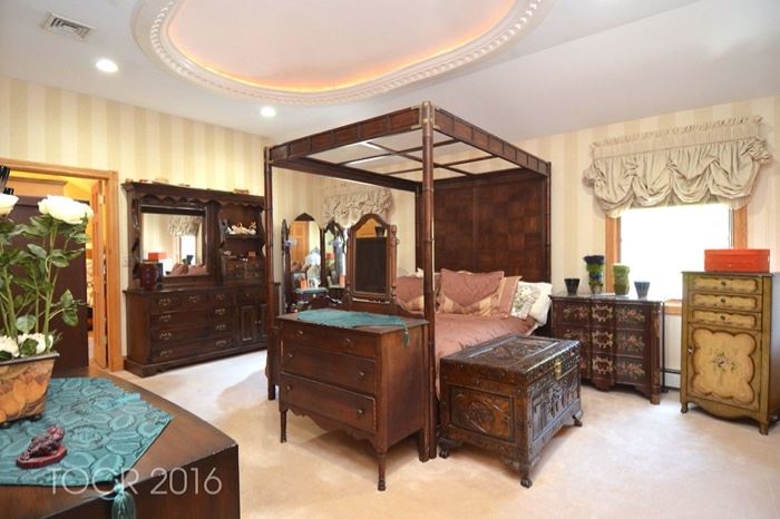 Beautiful canopy bed and end tables and carved trunk