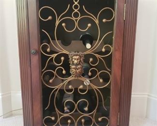 https://ctbids.com/#!/description/share/537449 Open Front Wine Cabinet with Removable Serving Tray. This lion will protect your most treasured bottles of wine. Gorgeous wine cabinet with an open front and glass covered tray. Tray can be removed for serving. Magnetic closure on door and an area to store your wine glasses. Measures 22.5" wide, 16.75" deep, and 34.5" tall. Contents not included. Smoke free home.