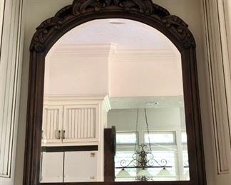 https://ctbids.com/#!/description/share/537520 Arched Mirror with Ornate Wood Carvings. Beautiful bevel edged mirror with arched top. Solid wood frame surrounding with ornate carvings across the top.