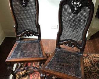 https://ctbids.com/#!/description/share/537620 2 French Caned Side Chairs. Matching pair of dark stained walnut side chairs with caned seat and back. Elaborate carved details on the top of backs and legs. Beautiful details on front and back. In beautiful condition. One chair has minor separation of caning along back edge.