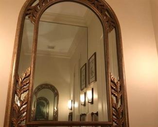 https://ctbids.com/#!/description/share/537622 Arched top mirror with decorative gold leaf motif around corners and top. Dimensions are 43'' x 28''.
