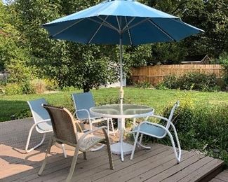Some of the patio furniture, This set has four white and blue chairs, there is a pair of the beige
