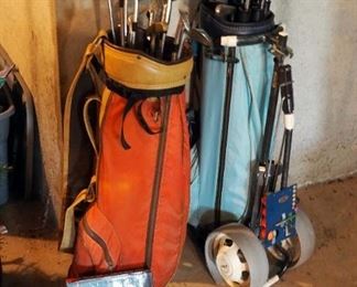 Vintage His And Hers Golf Clubs Including Wilson And Dunlop Clubs, Rolling Golf Bag Carts, & Golf Club Cleaning Kit