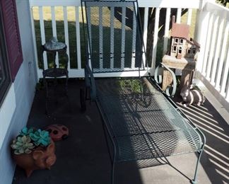 Metal Chaise Lounge, Plant Stand, Terra Cotta Pig Planter, Decorative Birdhouse, And Metal Ladybug
