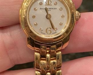 Baum & Mercier Ladies 18k gold watch, with mother of pearl and diamond face. In excellent working condition. $2,650