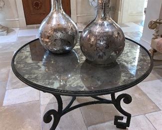 Iron table by Formations - circular top inlaid with mirrored panel. Greek key motif and scrolled legs 29"x40"d - Price $1,800 (vases have sold)