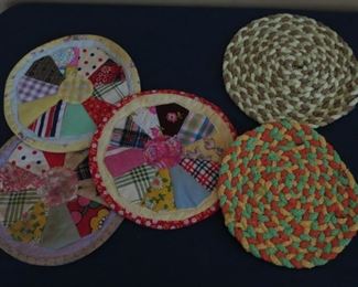 HOME MADE QUILTED AND BRAIDED POT HOLDERS.