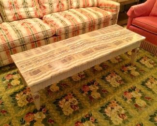 Veined Marble Top coffee table with carved wood legs.