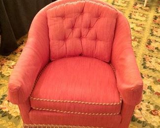 Upholstered club chair with button tufted cushion and frill bottom.