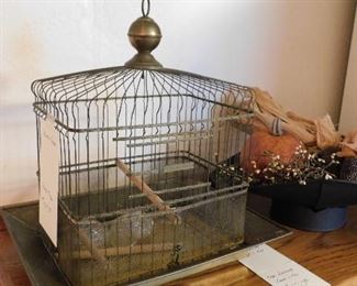 Vintage birdcage with feeders and perches