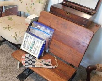 Upholstered arm chair. Antique school desk. Vintage Christmas ornaments.