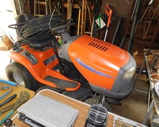 Older Husqvarna riding mower. Runs great, cuts grass! There are 3 soaker hoses on the seat. 