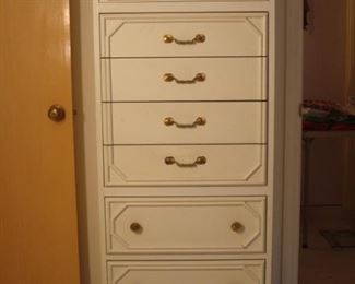 Bedroom #2:  A white lingerie chest has eight drawers with brass pulls.