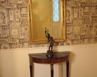 Foyer:  An arch top/multi-panel mirror (26" wide x 43" tall) hangs above a small demilune table with detached marble top.  A metal soldier greets you as you enter the door.