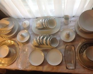 Dining Room:  Classic white china with a platinum rim is by NORITAKE ("Freemont" pattern).  This set includes: 12 dinner plates; 12 bread & butter plates; 12 saucers; 12 cups; 12 fruit bowls; 1 oblong platter; 
3 serving bowls; 1 gravy with attached under-plate; 1 lidded sugar; 1 creamer; 1 salt; and 1 pepper, for a total of 69 pieces.
