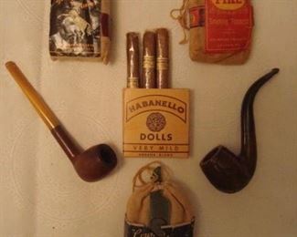 SMALLS Area-CASE:  For the tobacconist in your life: 
a small STUD bag with various papers (see next photo); small bags of smoking tobacco (PIKE and COUNTRY GENTLEMAN; HABANELLO DOLLS mild cigars; a French Briar straight stem pipe with bakelite mouthpiece; and a Genuine Briar "egg" pipe.