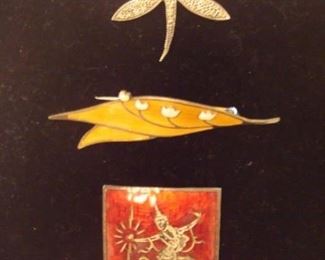 SMALLS Area-CASE:  Three sterling pins are individually priced: butterfly with marcasite and mother of pearl; enameled leaf; and a red SIAM.