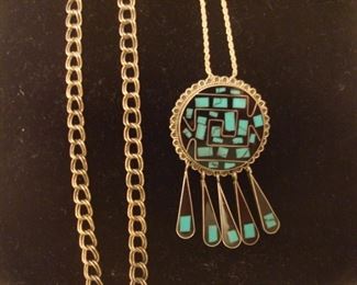 SMALLS Area-CASE:  A sterling link chain is to the left of a newer sterling/turquoise pin/pendant with sterling chain.