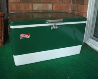 Sun Room: A green metal COLEMAN cooler has a slight dent in it but it still works!  Its original box is also available.