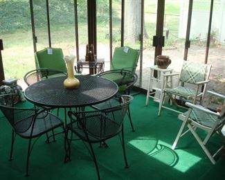 Sun Room:  A round patio table with four chairs is priced as a set.  In the background are two individually priced spring-back chairs with green cushions.  Closer photos of the other items follow.