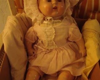 Lower Level:  A vintage "open-mouth" doll is priced along with various doll clothes and a blanket.