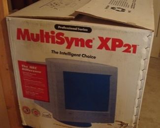Lower Level:  A MULTI-SYNC XP21 monitor by NEC is still in its original box.