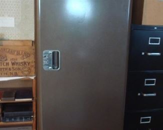 Lower Level:  A vintage brown metal cabinet is great for storage.