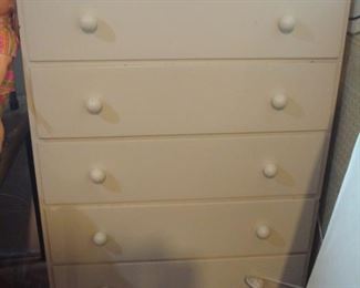 Lower Level:  A vintage 5-drawer chest is a creamy white. 