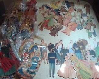 Lower Level:  This is just SOME of hundreds of vintage (1930's-1940's) paper dolls.  All are packaged in plastic bags.  We took some out to show you the beautiful gowns the women are wearing and the uniforms the men are wearing in this specific set.