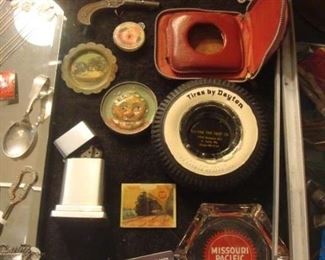 SMALLS Area-CASE:  Vintage American Legion Medals (1924, 1935, 1939, 1953 and more) are displayed above a vintage iron cap gun; vintage pocket games; a red leather pocket watch case; a collectible "Tires By Dayton" tire ashtray; octagonal MO-PAC ashtray; "First Man on the Moon" Stamps (1969-1989); and more.  Nearby but not photographed are vintage military patches.