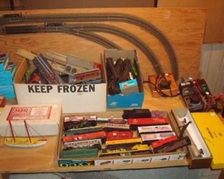 Lower Level:  In the background are a "box lot" of train buildings; a "box lot" of track; and individually priced trains and transformers.