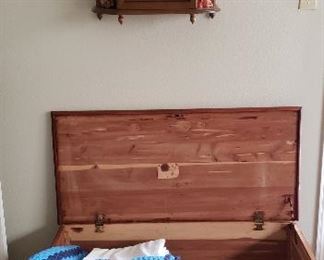 Cedar chest, afghans, wall shelf