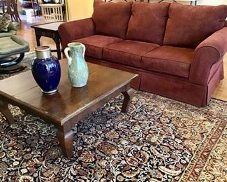 Ashley Sleeper Sofa, Square Distressed Coffee Table, and a gorgeous Area Rug.