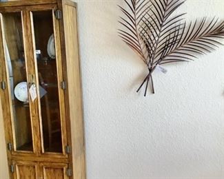 Metal Art Palms and a lighted curio