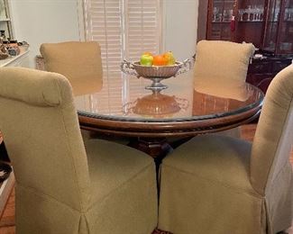 45 inch round wood table with additional glass  top, & four lovely Avocado green fabric covered Parsons chairs. 