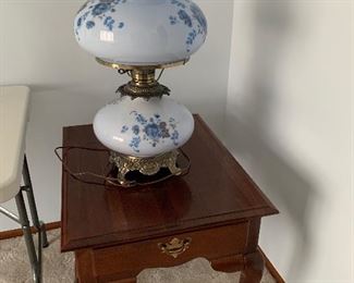 End table and Vintage Milk Glass Hurricane lamp that lights up top & bottom  with blue tint and floral design.