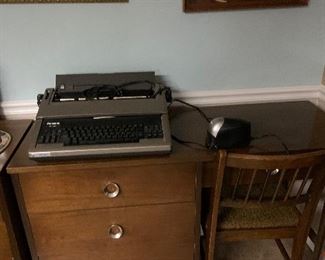 Vintage desk and chair that matches dresser.  Working Panasonic electric typewriter also shown.