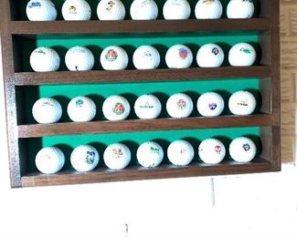 Display case with 28 golf balls collected all over the United States. (There is also a 2nd case with 66 collected balls in it.)
