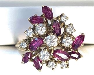 14KT yellow gold cast colored stone and diamond cluster ring with a high polish finish. It contains 9 prong set marquise modified brilliant cut natural rubies. The total weight of the Rubys is 0.63ct. It also has 10 prong set round brilliant cut diamonds with an approximate total weight of a 10 stones equaling 0.48ct.