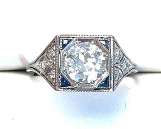 Platinum Antique Style Diamond Ring Containing A Bead Set Transitional Cut Diamond With An Approx. Weight of 1.03ct. It also has six bead set single cut diamonds with an approx total weight of 0.10ct. and four bezel set triangle brialliant cut natural blue sapphires with an approx total weight of 0.10ct.