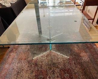 Glass dining table on glass supports
