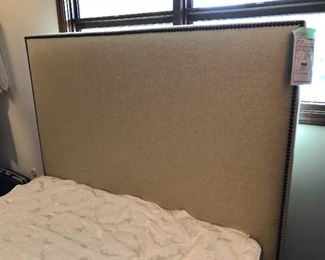 New with tag queen headboard - upholstered with nail head trim in a pale green